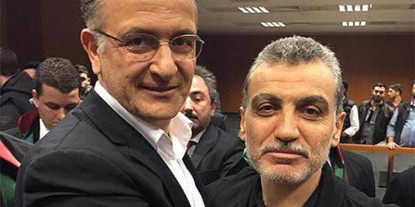 Zaman daily Editor-in-Chief Ekrem Dumanlı (L) and Samanyolu Broadcast Group head Hidayet Karaca (R) pose smiling at the camera after the announcement of the ruling. (Photo: Cihan)