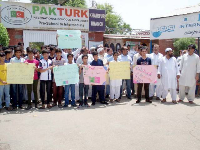 The students and their parents carried placards with slogans in favour of Pak-Turk School and expressed solidarity with the school management. PHOTO: EXPRESS