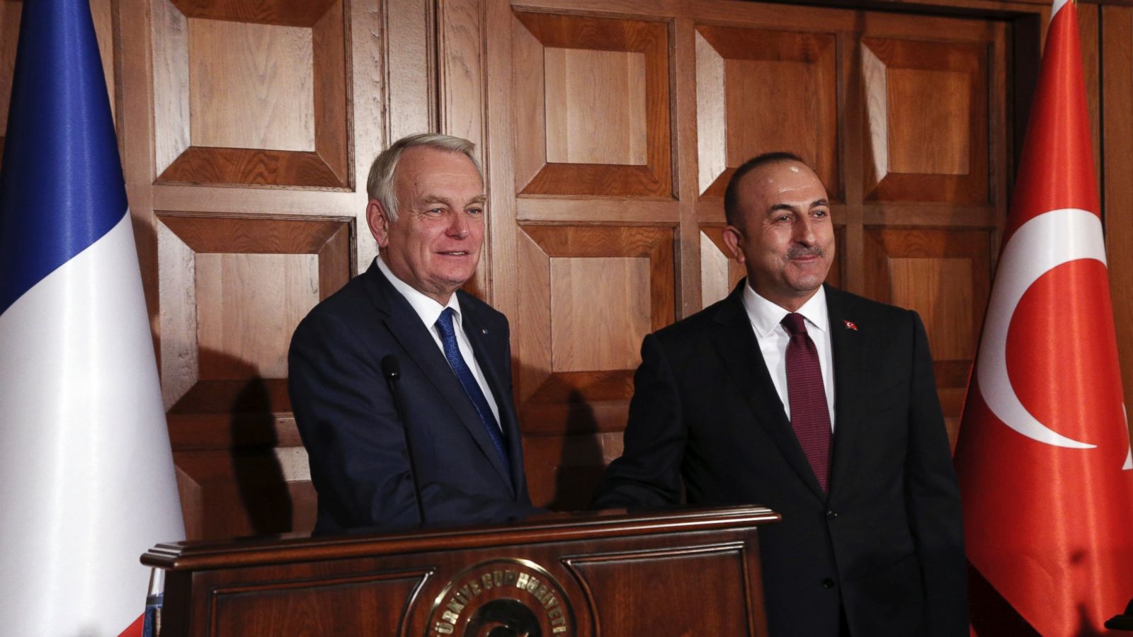 France's Foreign Minister Jean-Marc Ayrault, left, and his Turkish counterpart Mevlut Cavusoglu shake hands after a joint news conference in Ankara, Turkey, Monday, Oct. 24, 2016. Ayrault has called for an end of the 