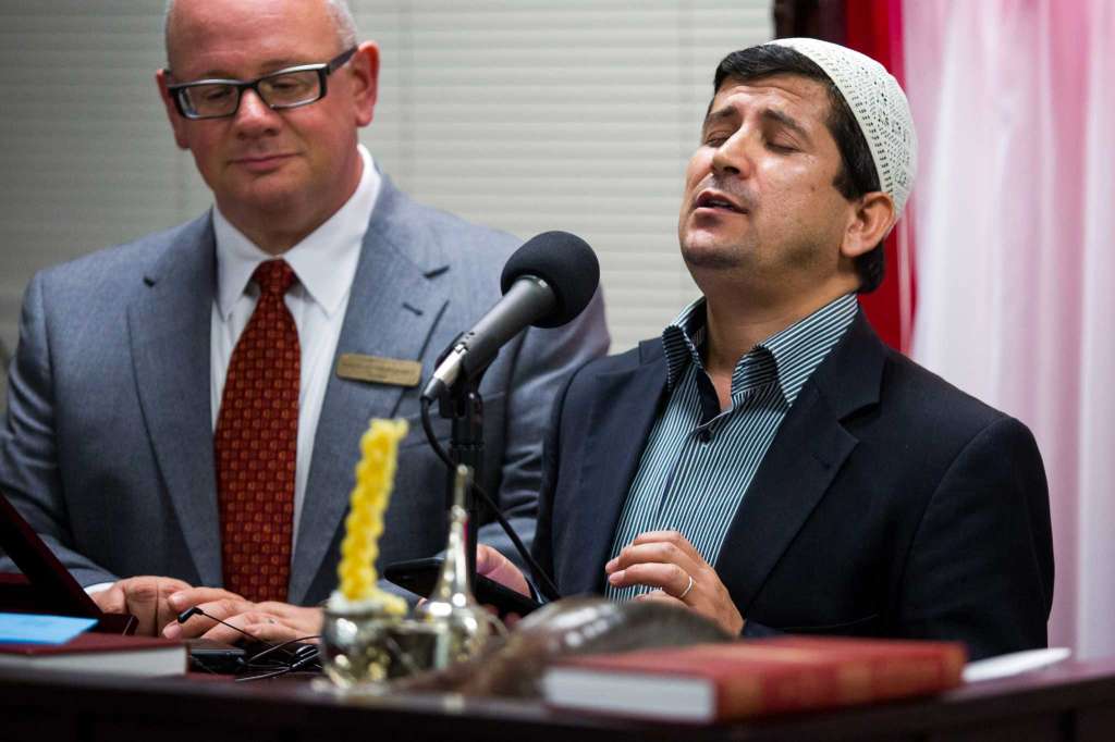San Antonio, Texas -- October 12, 2016 -- Beytullah Colak, Imam of the San Antonio chapter of The Islamic Institute, sings a prayer with Rabbi David Komerofsky at his side during a dinner to break the Yom Kippur fast at Temple Chai. Ray Whitehouse / for the San Antonio Express-News