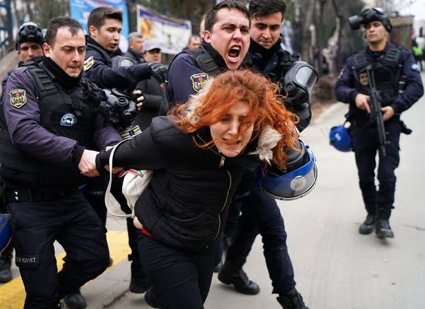 Riot police detain a demonstrator during a protest against the dismissal of academics from universities following a post-coup emergency decree, outside the Cebeci campus of Ankara University in Ankara, Turkey, February 10, 2017. REUTERS/Umit Bektas